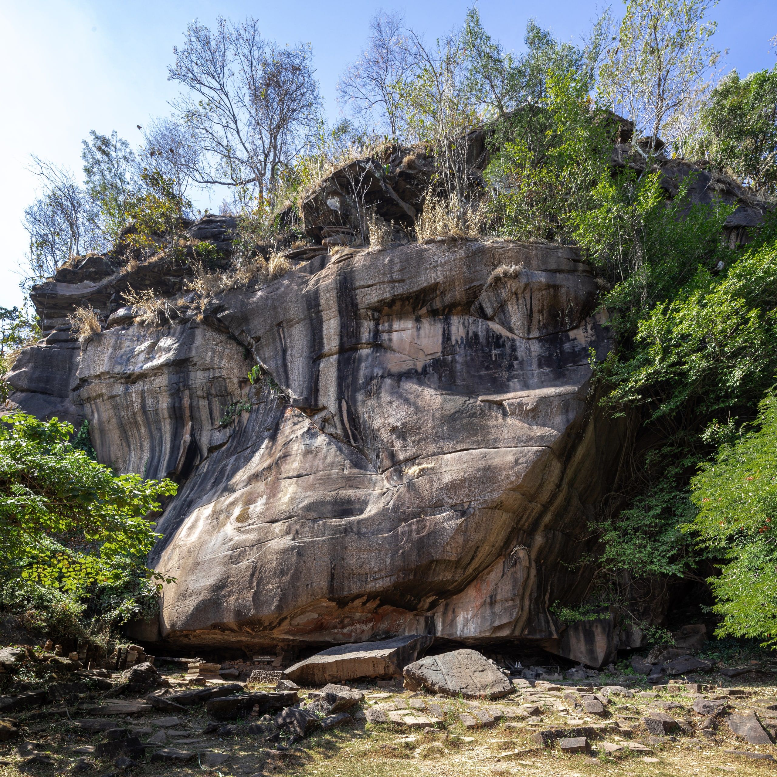 The cliff and sacred spring on the sixth terrace of Vat Phou
