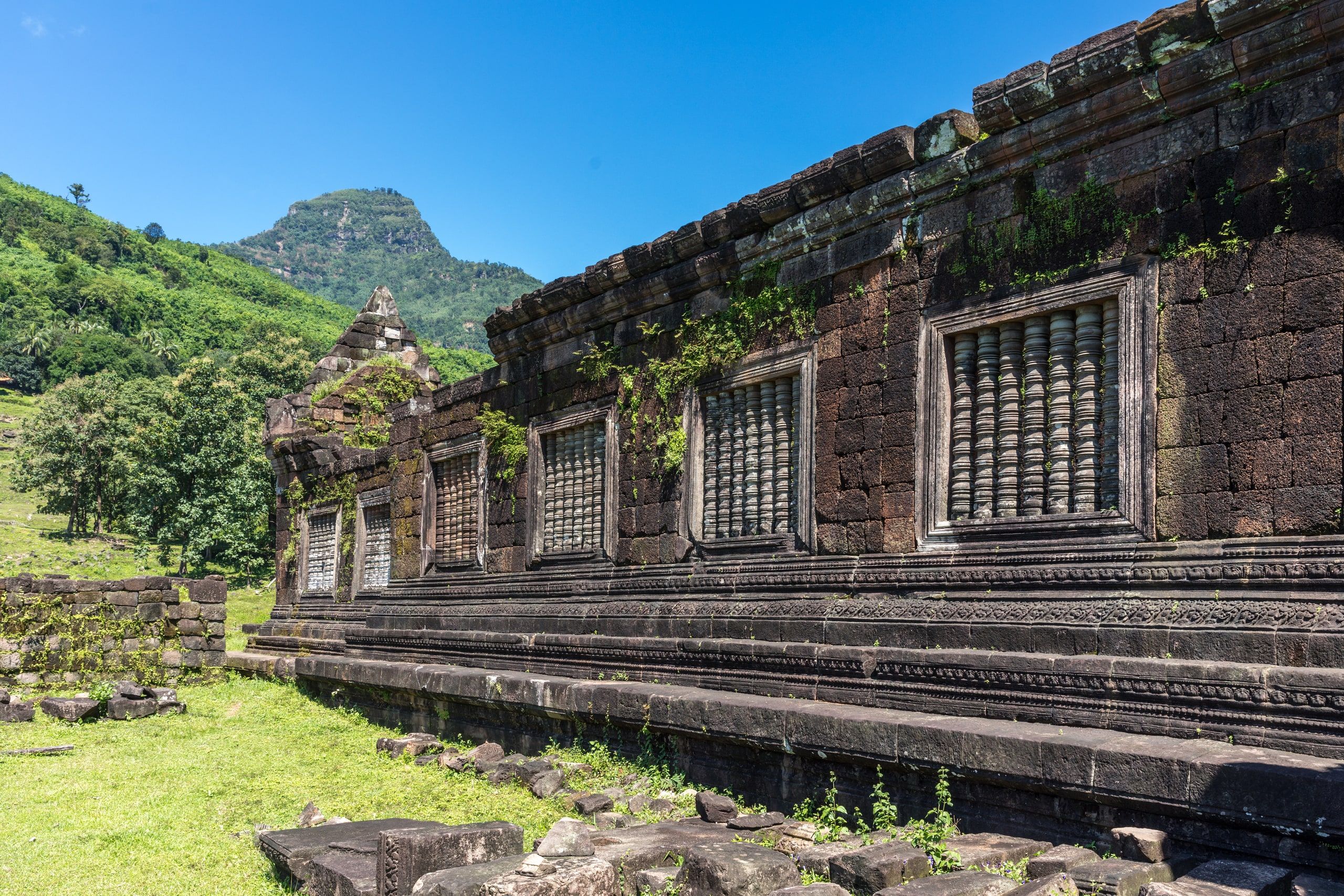 The ruined facade of the northern palace at Vat Phou, its sandstone balustered windows