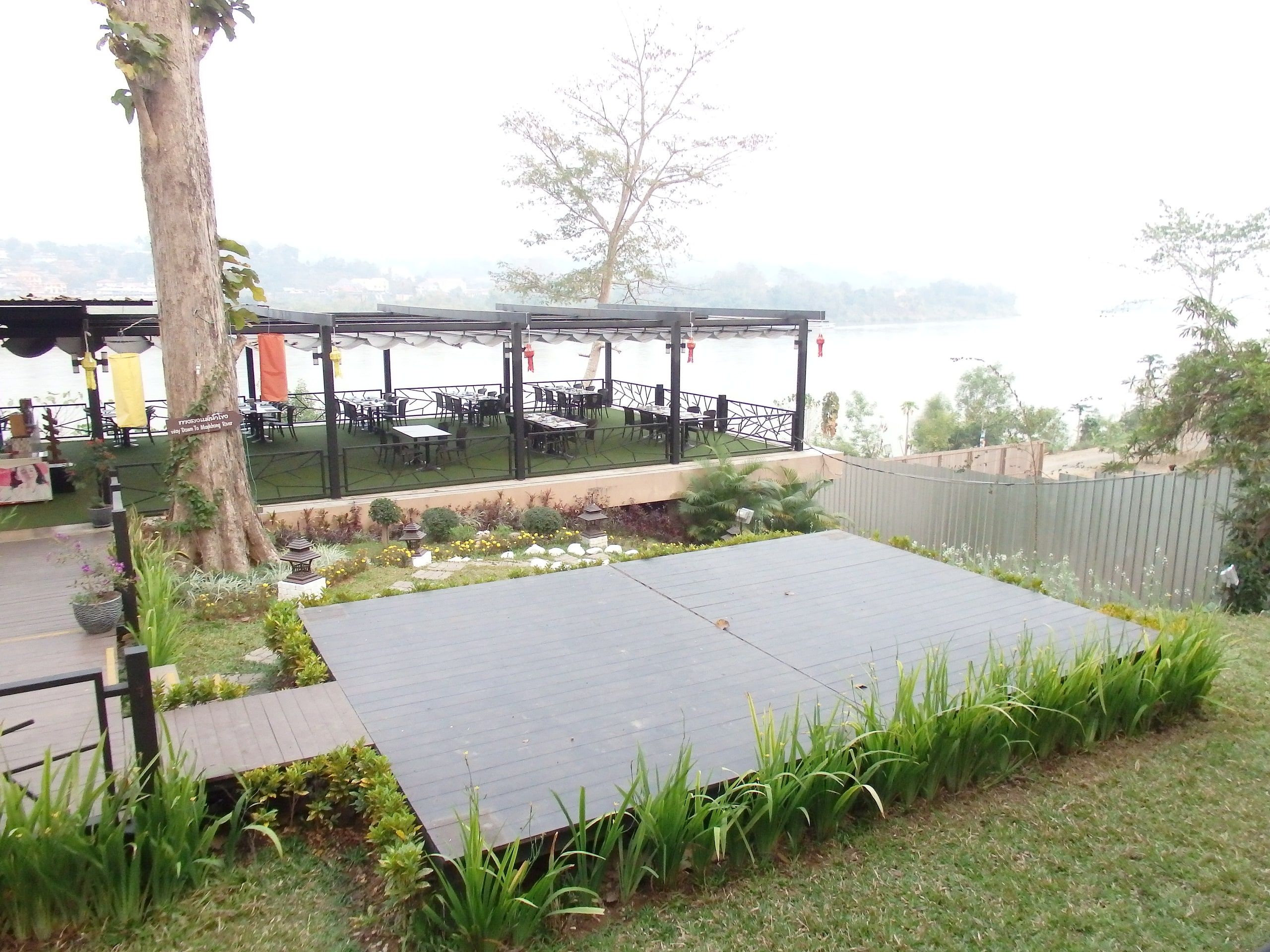 A restaurant terrace by the Mekong in Chiang Khong on a misty morning