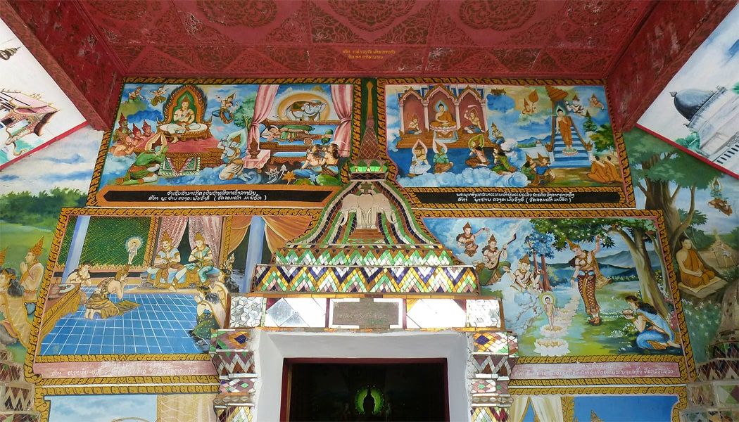 The murals painted above the door of Wat Chom Khao Manilat