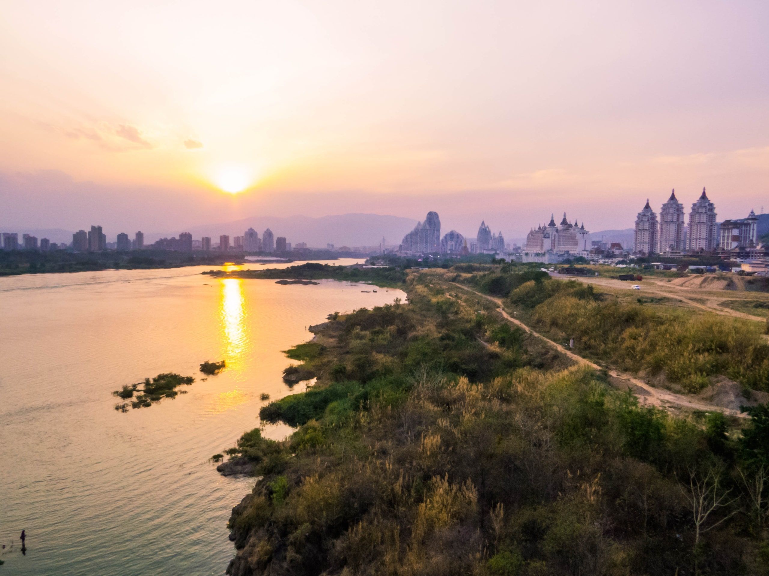 The Mekong at Jinghong at sunset, the city's towers on the bank