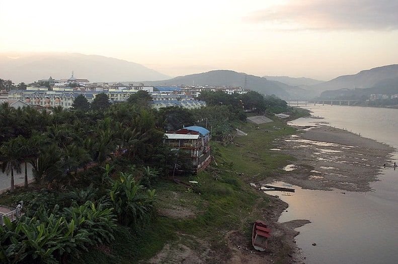The wide, low Mekong in front of Jinghong, sandbanks and hills in the haze