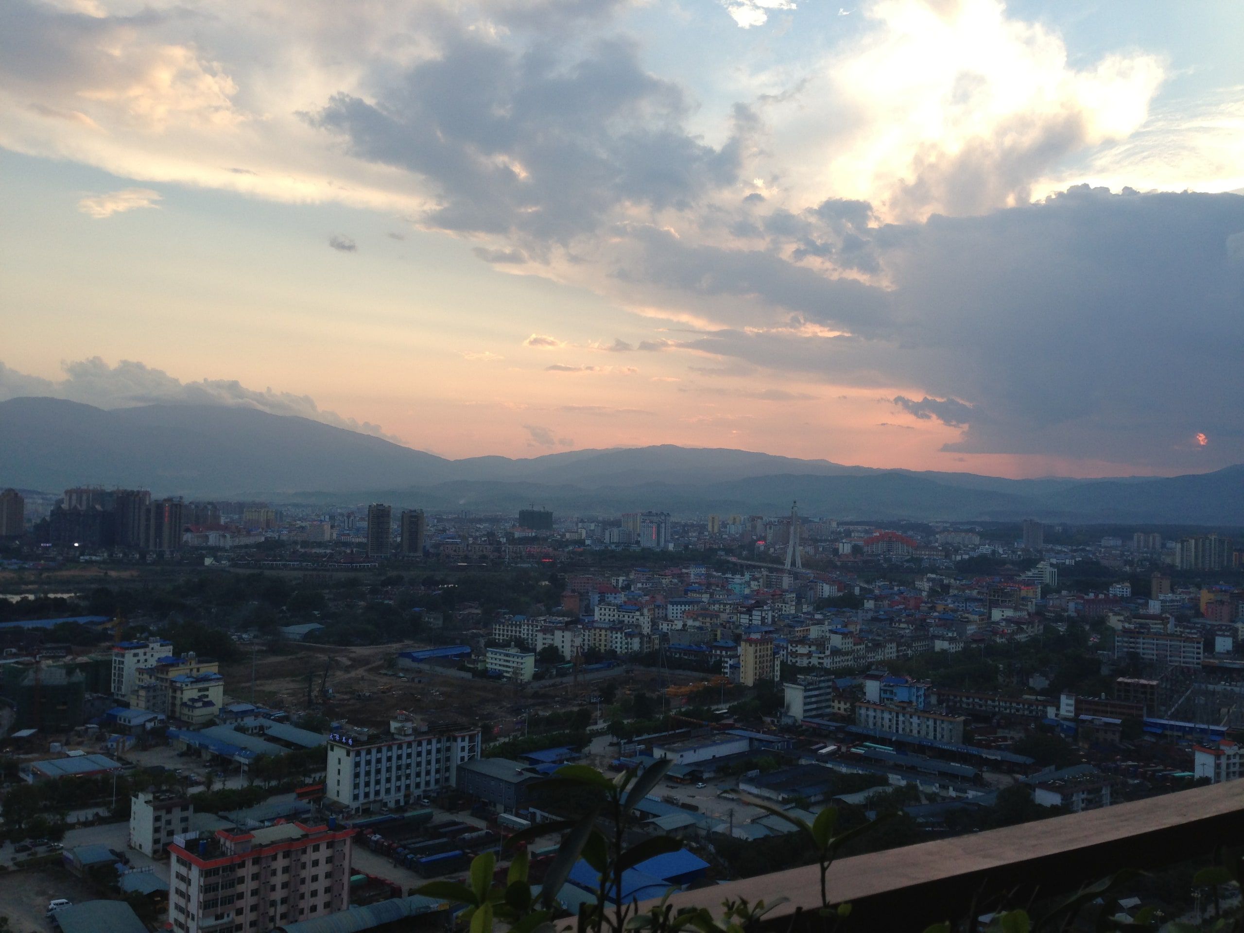 Jinghong from above, buildings at the foot of the mountains