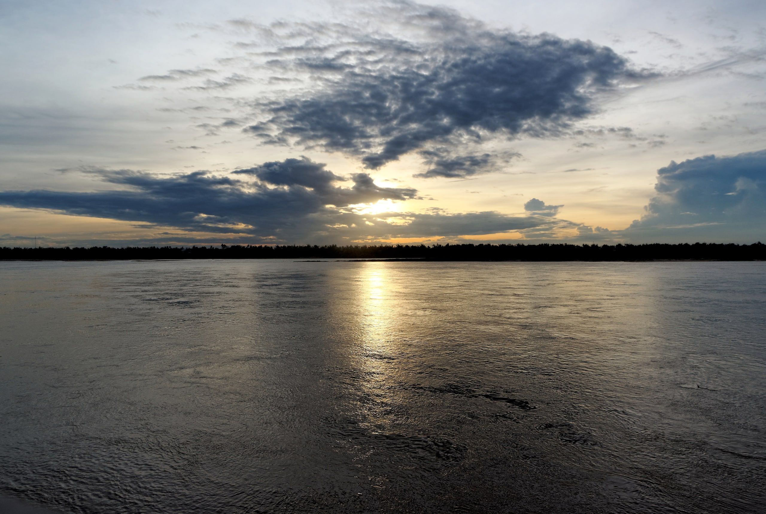 Sunset over the Mekong at Kratie under a cloudy sky