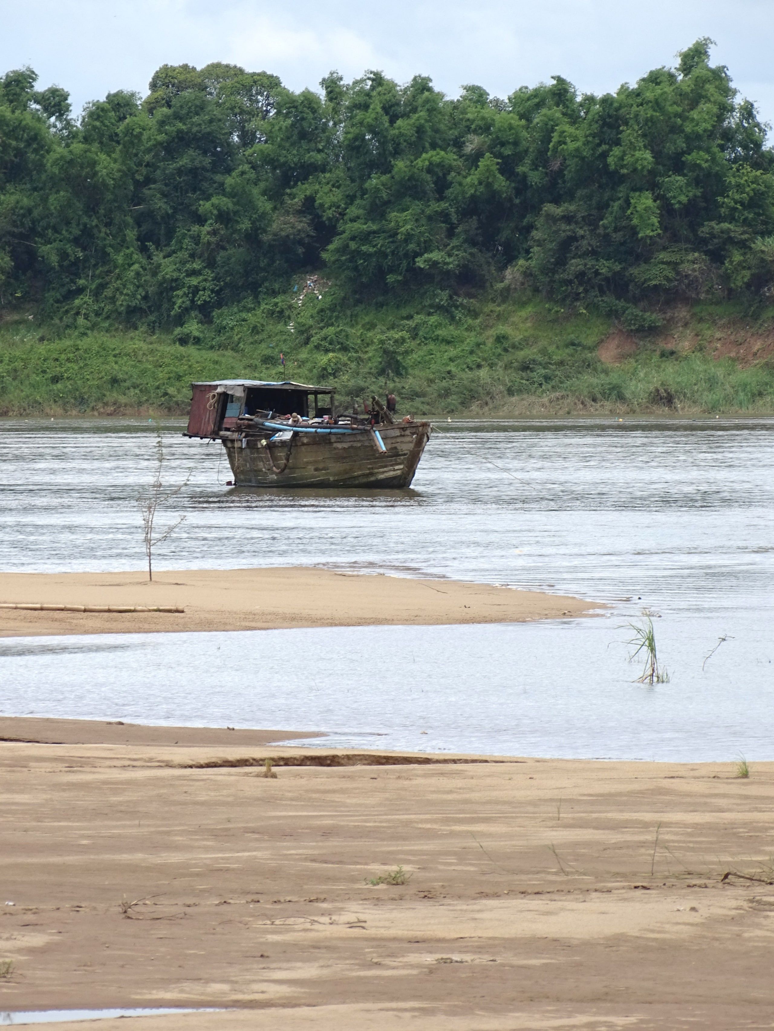 A boat grounded on a Mekong sandbank near Koh Trong