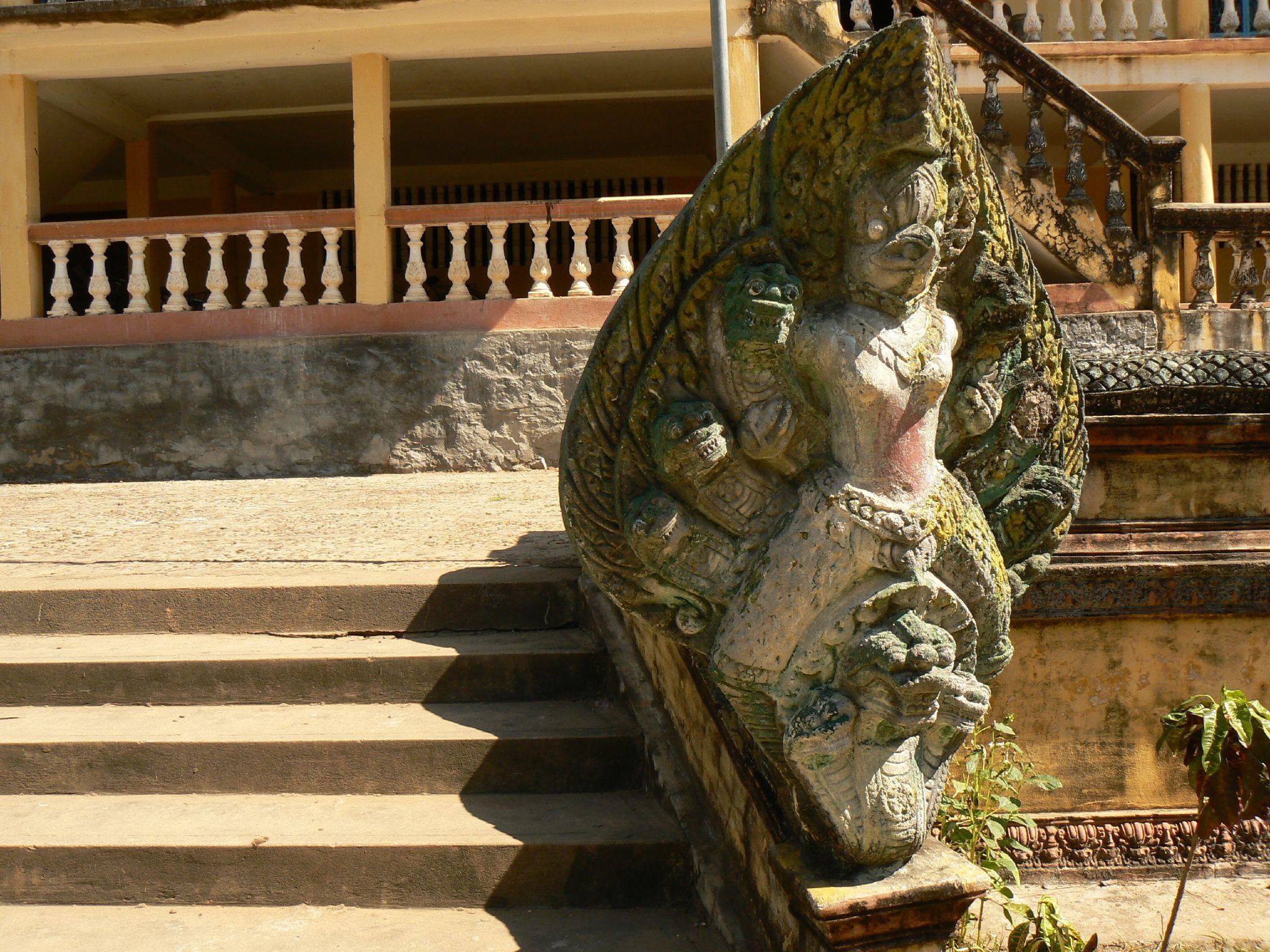 A carved naga at the foot of the stairs of the hundred-column pagoda