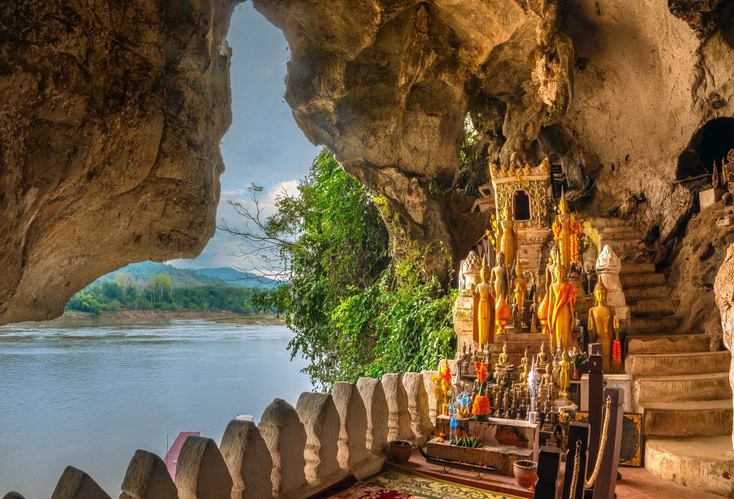 Buddha statues in a Pak Ou cave, open onto the Mekong