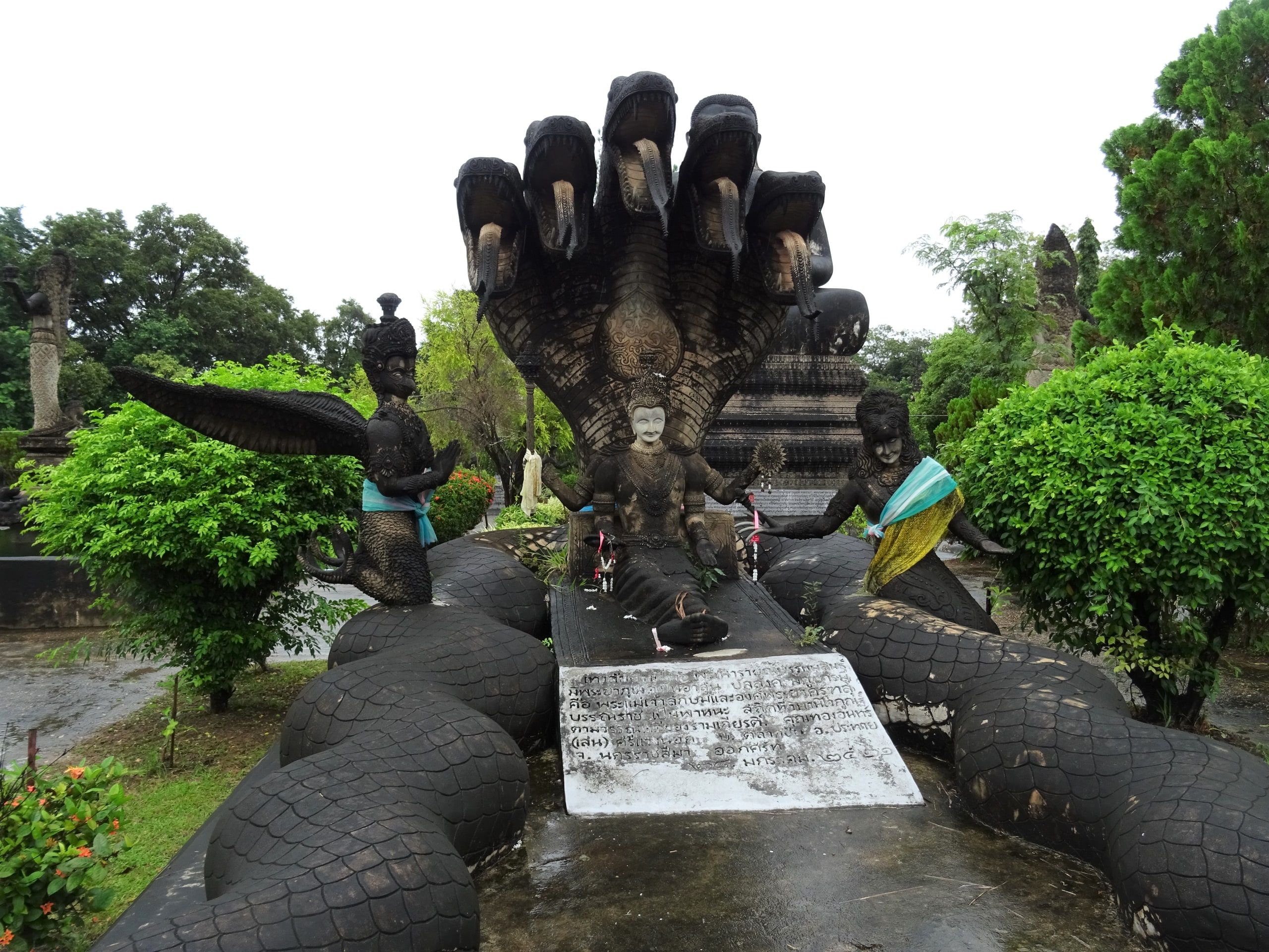 A seven-headed naga above a Buddha at Sala Keoku