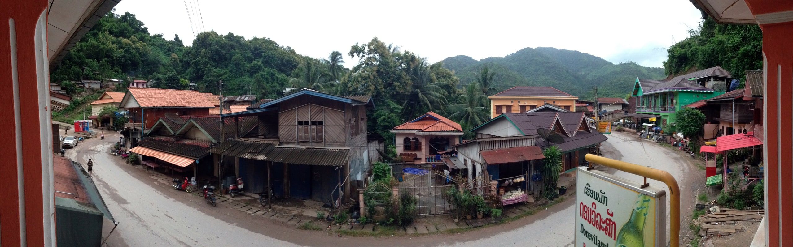 Panorama of Pakbeng's main street, its wooden houses and the hills