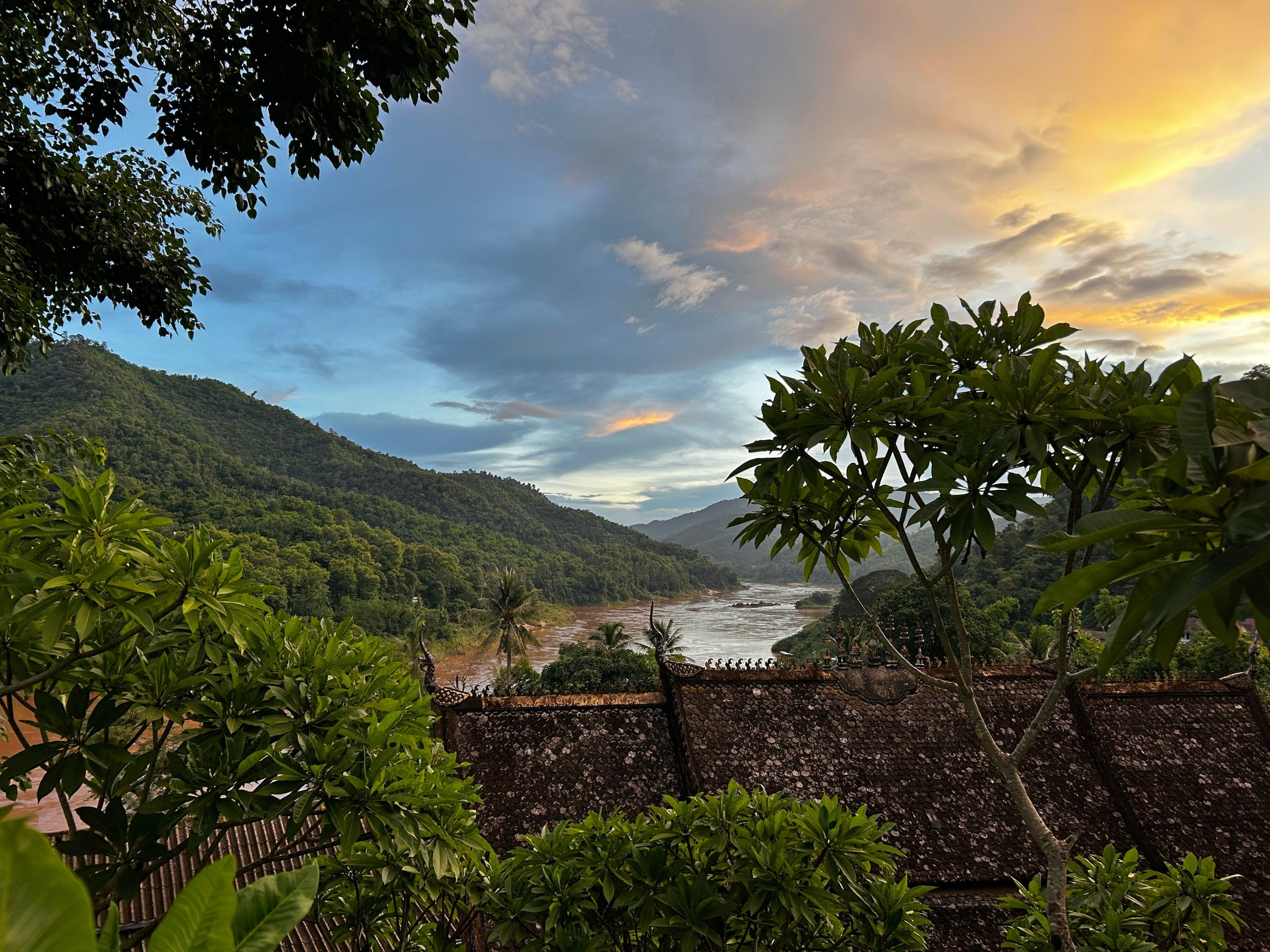 The Mekong and the wooded hills seen from above Pakbeng at sunset