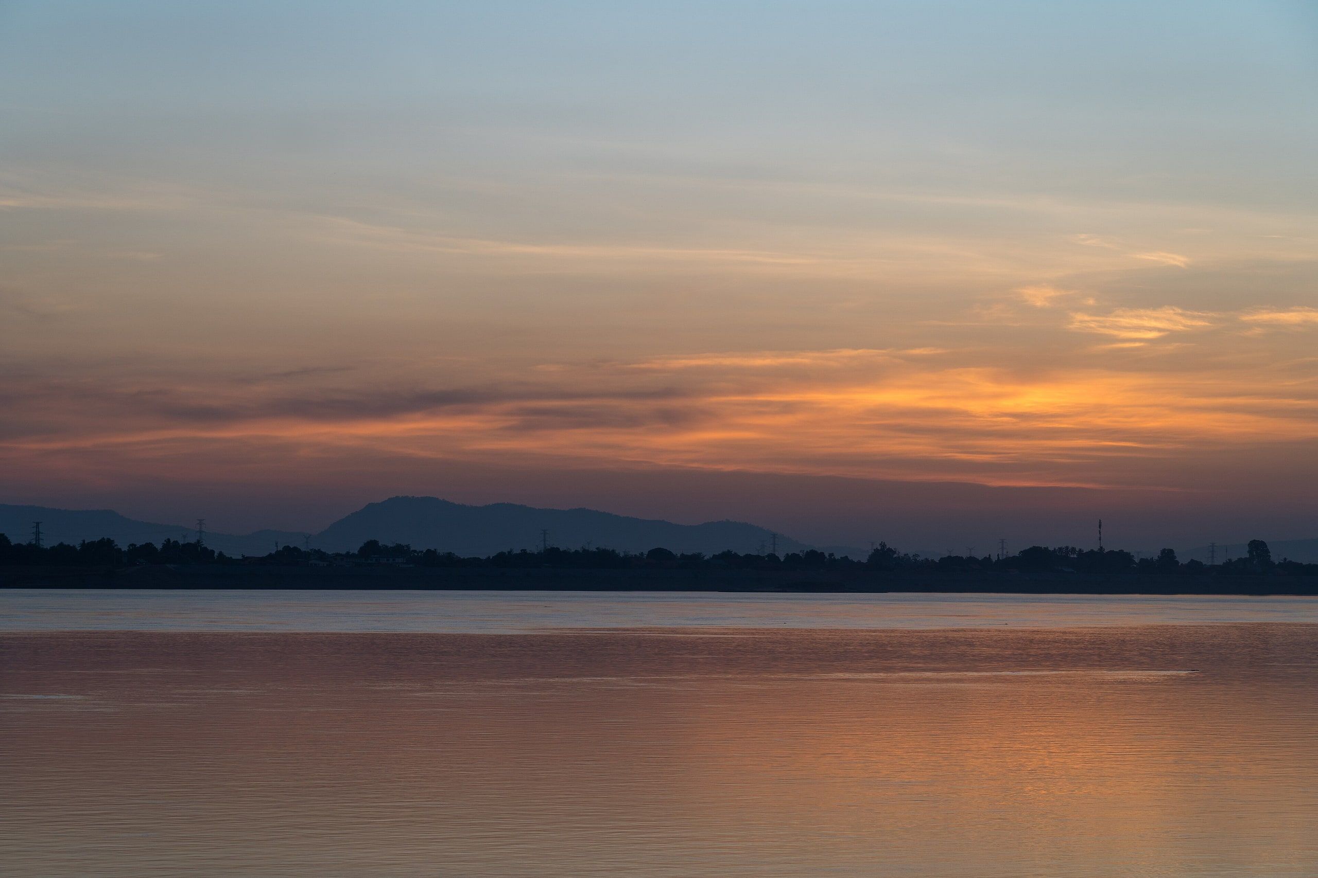 Sunset over the Mekong at Pakse, the mountains of the west bank in silhouette