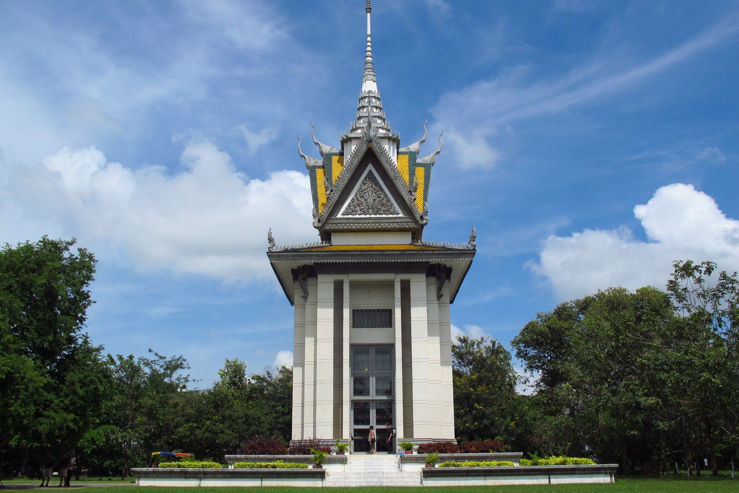 The Choeung Ek memorial stupa and its tiered roof among the trees