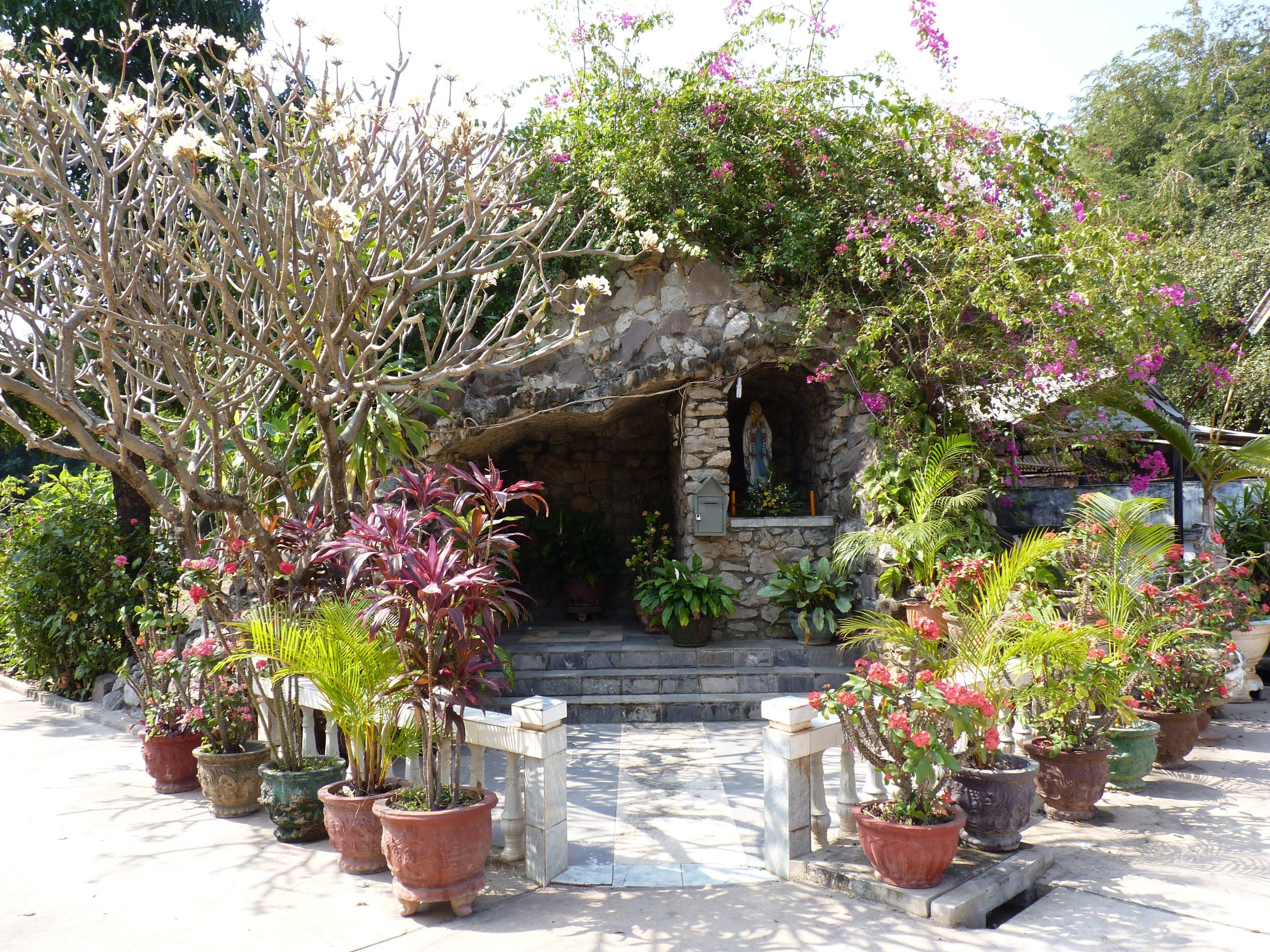 The flower-filled grotto in the garden of St Teresa's Church