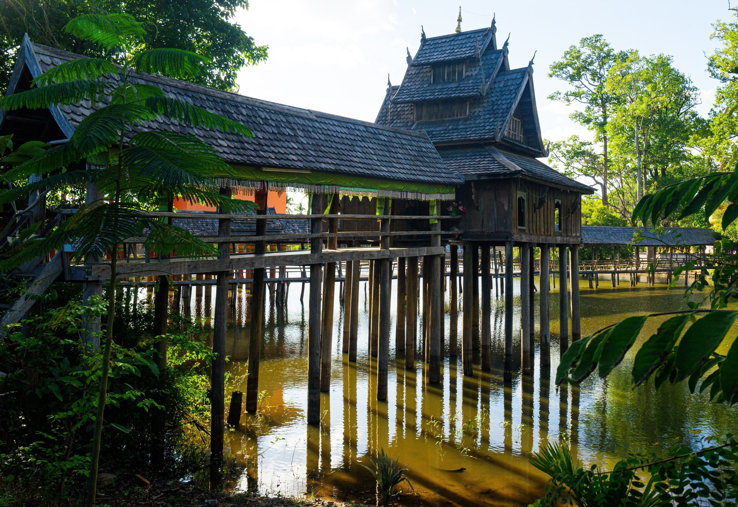 The Hor Tai Pidok library, a wooden building on stilts in the middle of a pond, at Ban Nong Lamchan