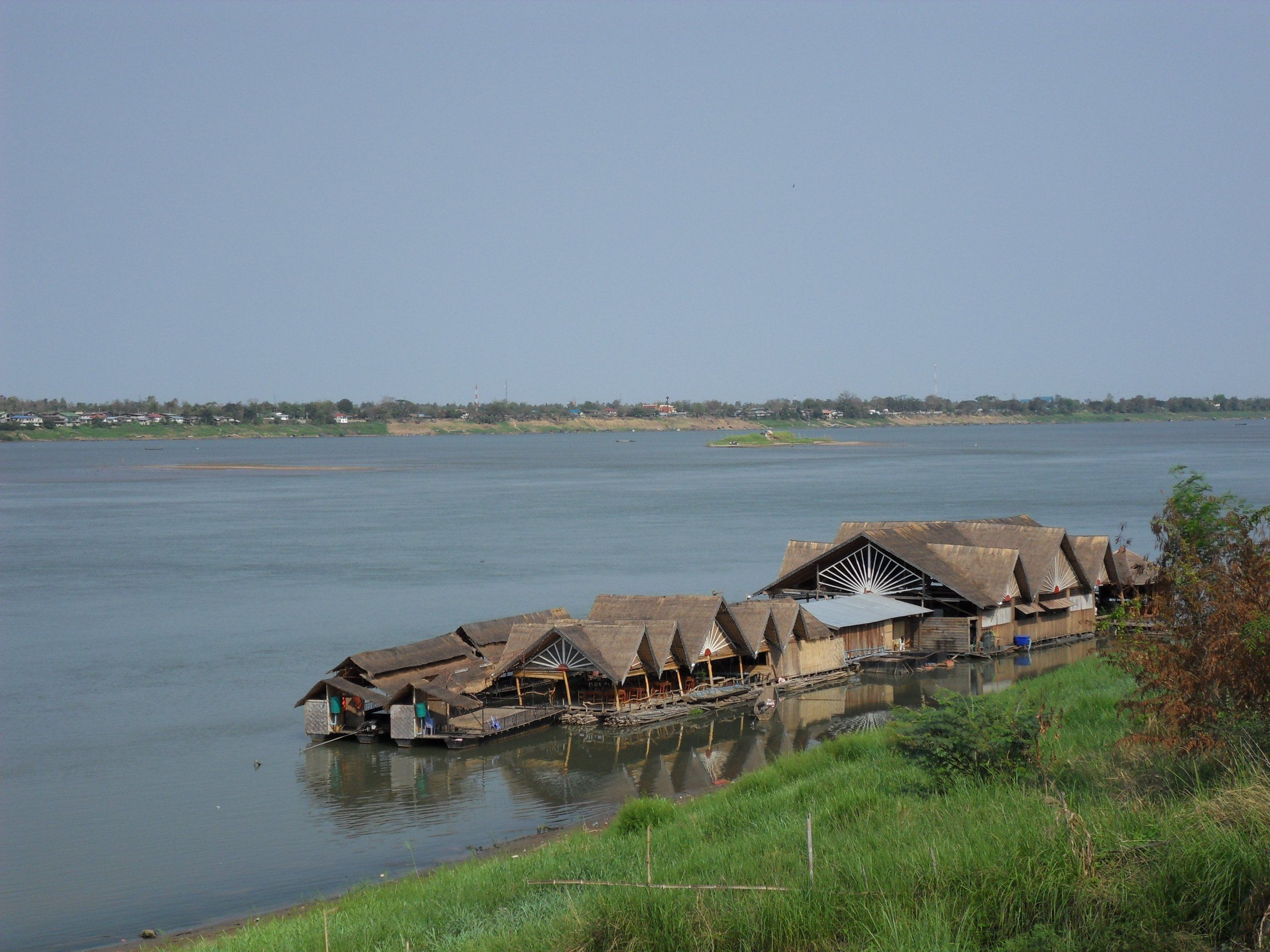 A floating restaurant moored on the Mekong, the Thai bank on the horizon
