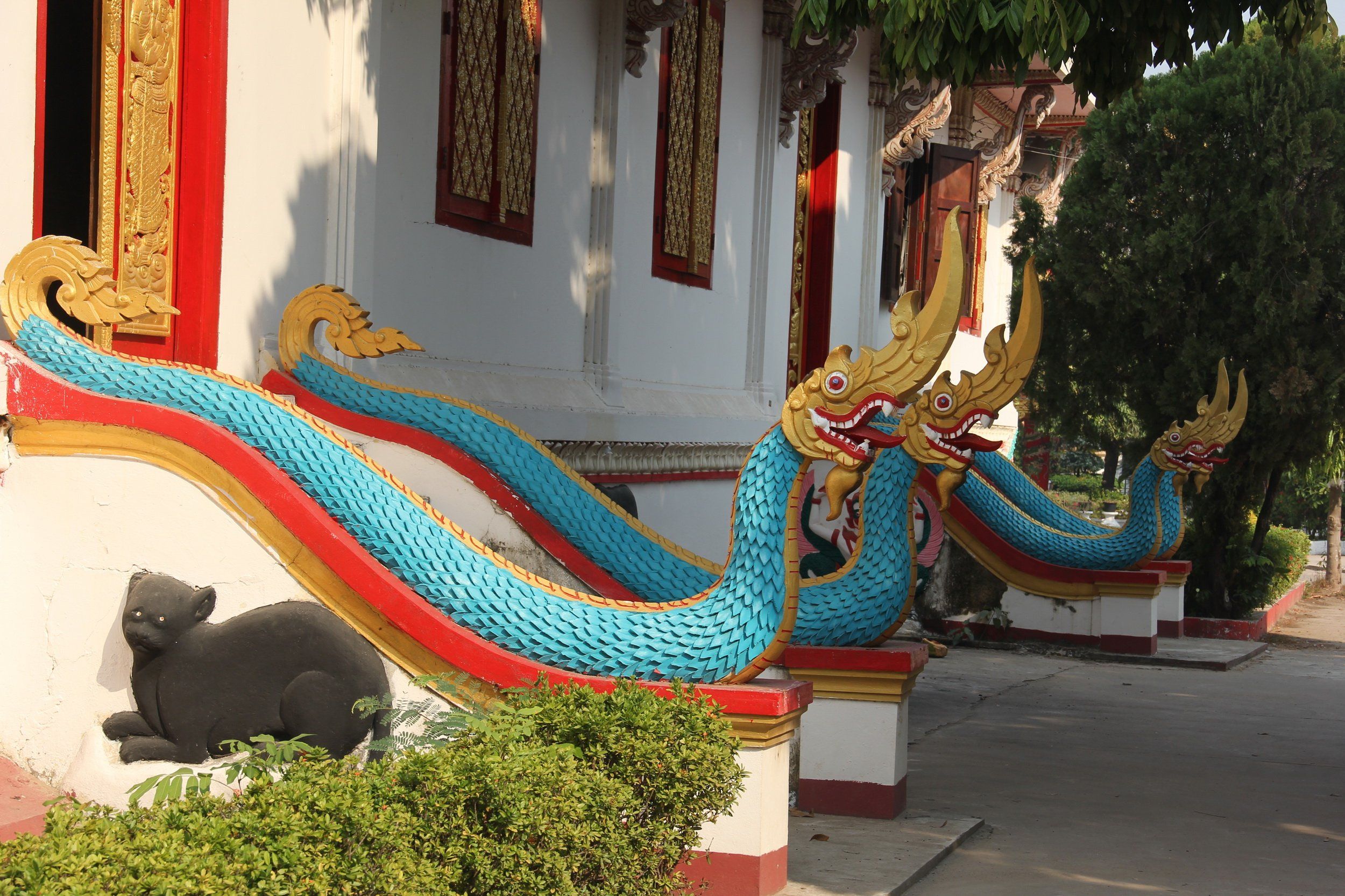 Colorful naga serpents along the stairway of a Wat Sainyaphum building