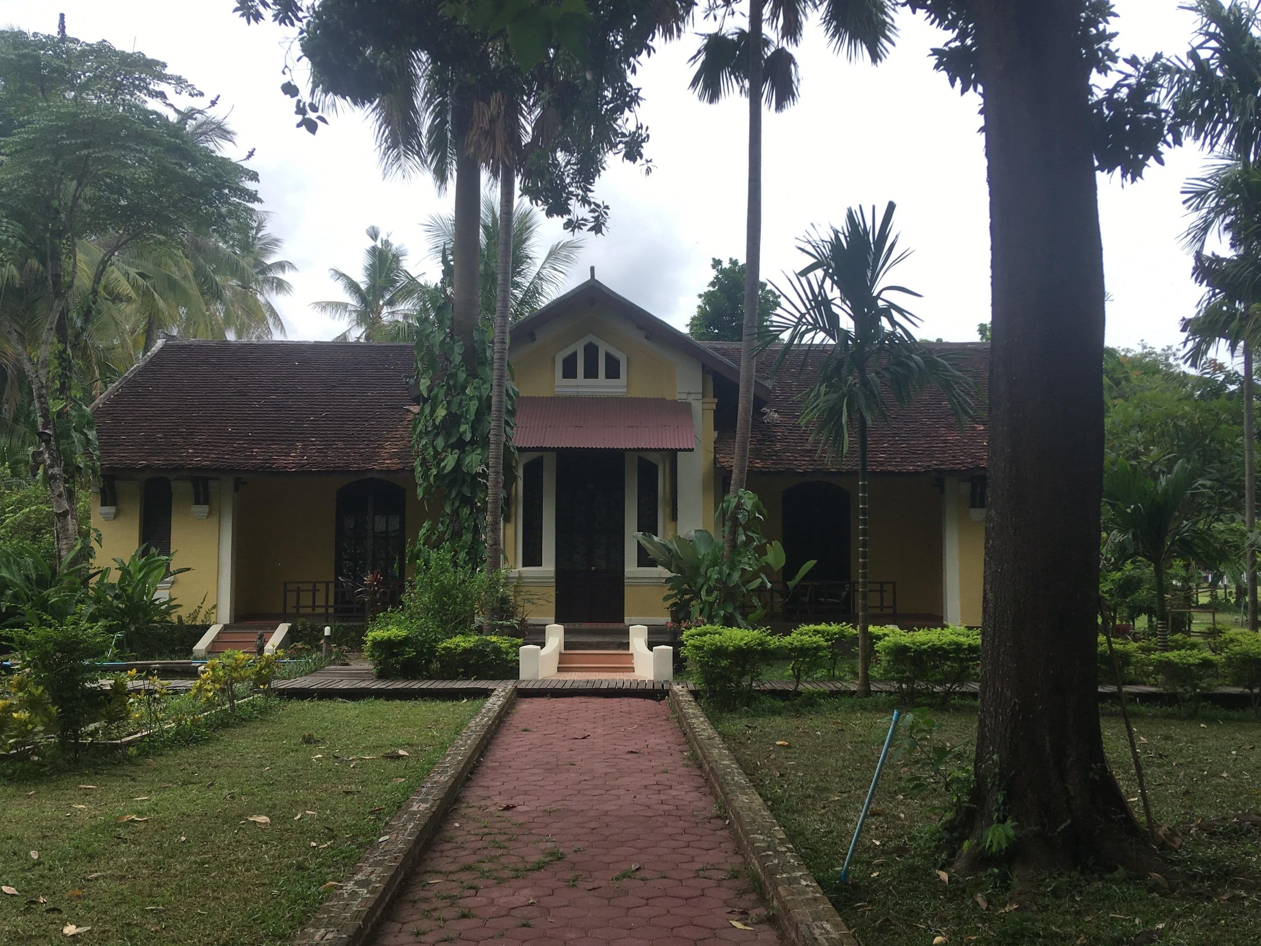 The colonial villa on Don Khon, at the end of a path under palm trees