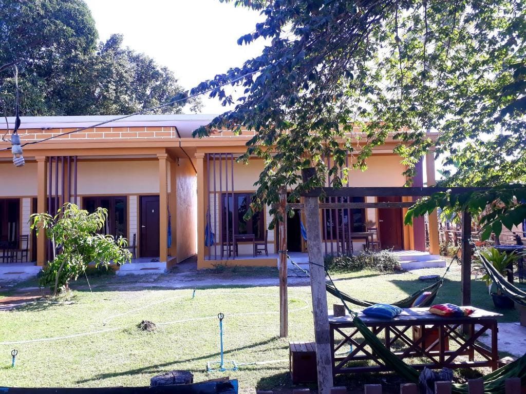 Moon By Night bungalows around a lawn, hammocks under a tree