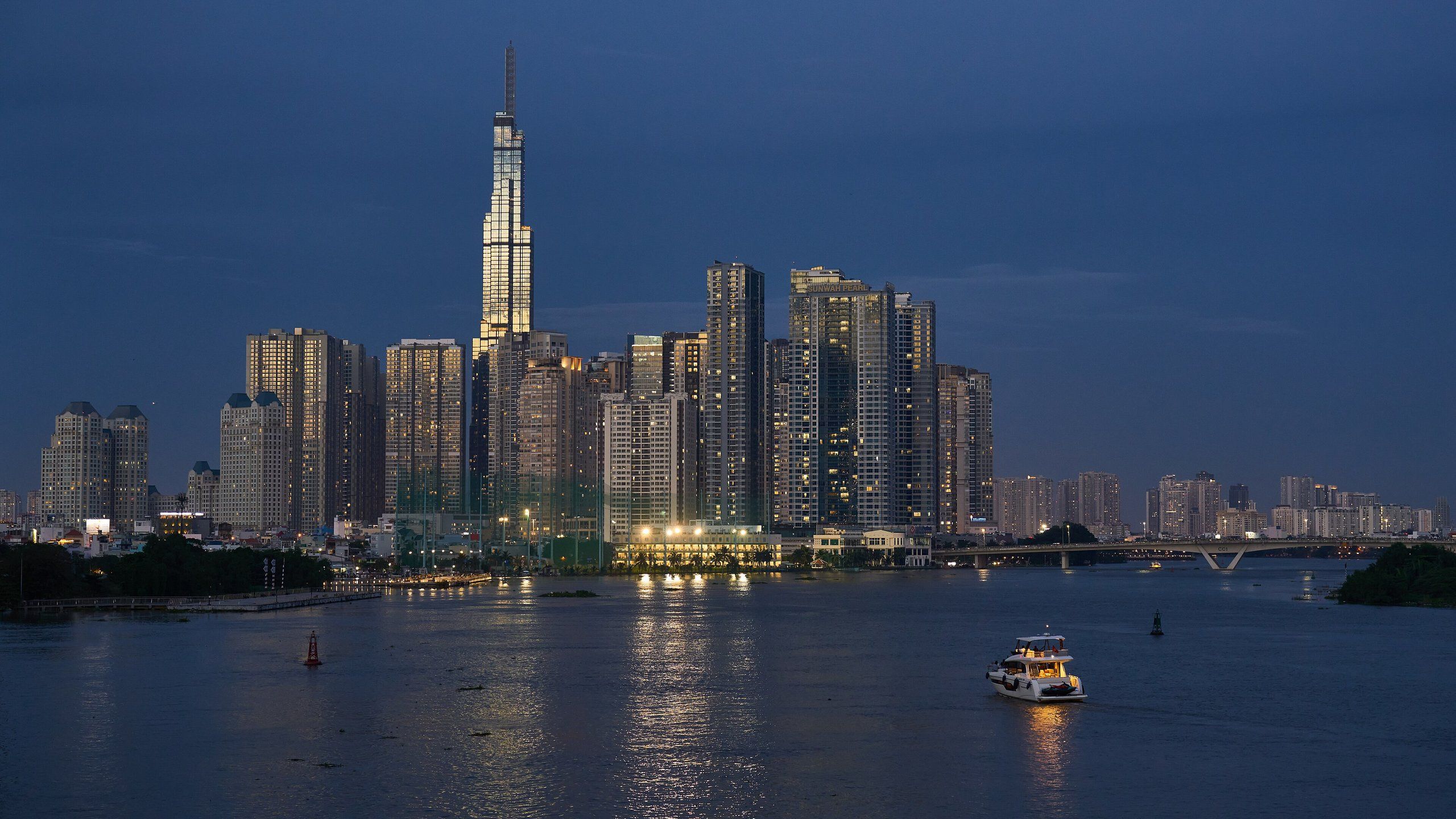 Ho Chi Minh City's towers at dusk, above the Saigon River